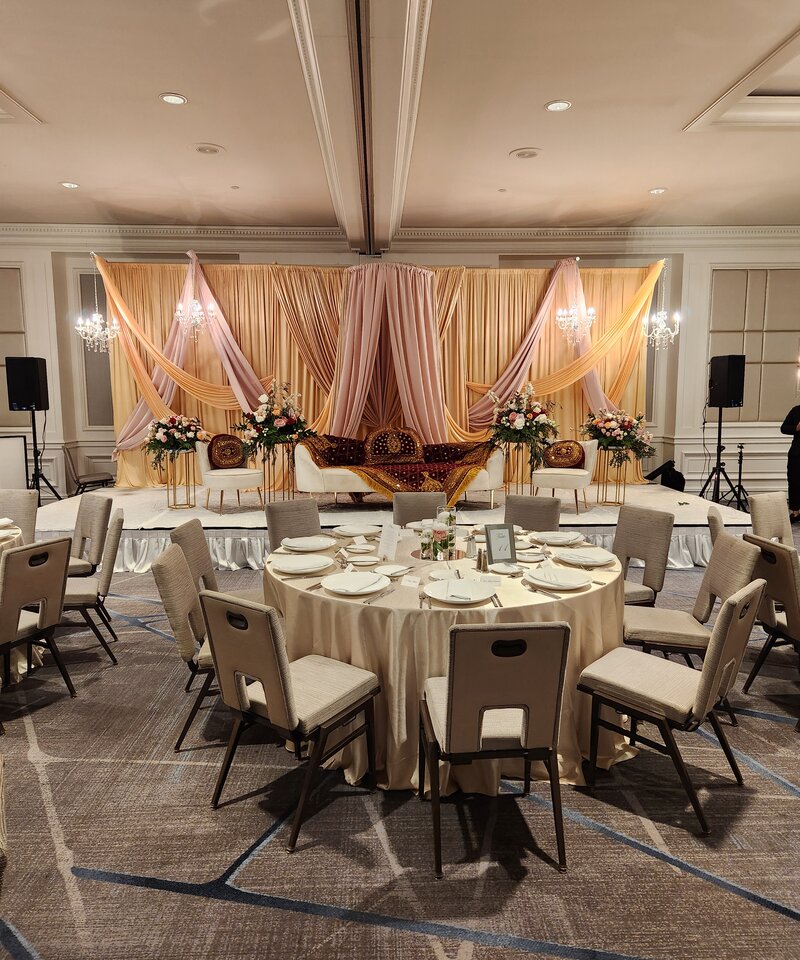 Walima reception ballroom blush gold chandeliers draped stage Columbus Ohio