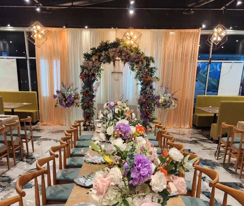 Fairytale garden floral arch stage with blush drapery by Events By Maryam