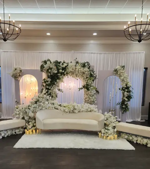 White floral arch stage with chandelier